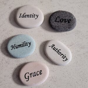 Five stones on a light background that say Identity, Love, Humility, Authority and Grace.