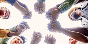 A group of people praying in a circle