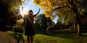 A woman with arms outstretched to the sun